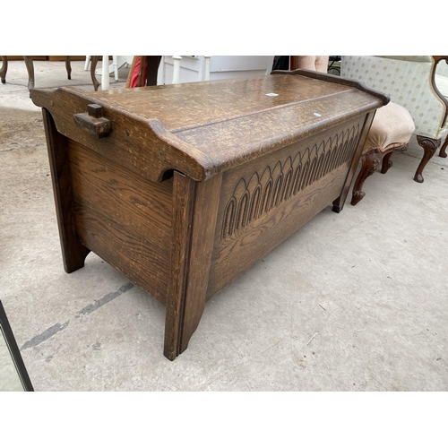 2451 - A REPRODUCTION OAK BLANKET CHEST WITH CARVED FRONT PANEL, 41