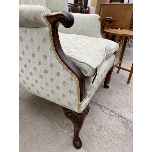 2453 - A VICTORIAN STYLE WINGED FIRESIDE CHAIR WITH SCROLL ARMS, ON FRONT CABRIOLE LEGS