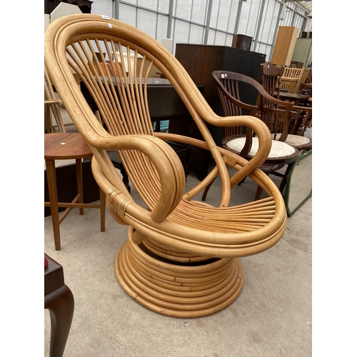 2469 - A MODERN BAMBOO/RATTAN SWIVEL CHAIR WITH SWEPT ARMS, ON TIERED BASE, LACKING CUSHIONS