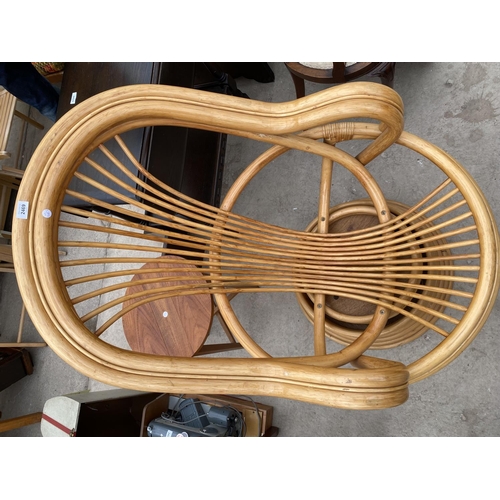 2469 - A MODERN BAMBOO/RATTAN SWIVEL CHAIR WITH SWEPT ARMS, ON TIERED BASE, LACKING CUSHIONS