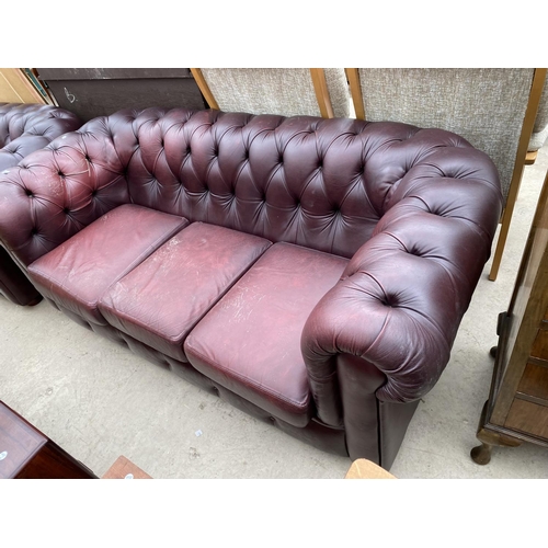 2474 - AN OXBLOOD CHESTERFIELD THREE SEATER SETTEE