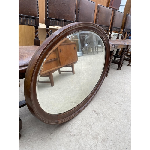 2477 - AN EDWARDIAN MAHOGANY OVAL BEVEL EDGE WALL MIRROR, 40x29