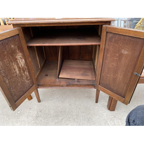 2498 - AN EARLY 20TH CENTURY PANELLED TWO DOOR CABINET ON OPEN BASE, 25.5