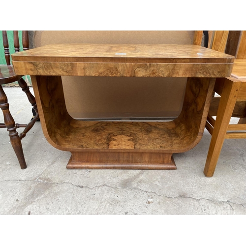 2518 - AN ART DECO WALNUT TWO TIER OCCASIONAL TABLE ON U-SHAPED BASE, BEARING PAPER LABEL 'MAPLE'S DEPOSITO... 