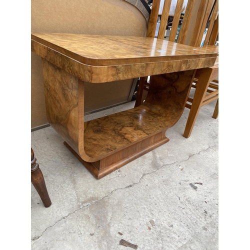 2518 - AN ART DECO WALNUT TWO TIER OCCASIONAL TABLE ON U-SHAPED BASE, BEARING PAPER LABEL 'MAPLE'S DEPOSITO... 