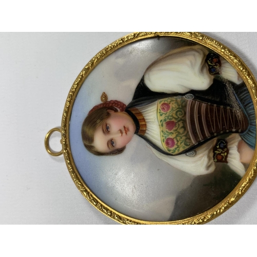 11 - A GILT FRAMED MINIATURE HAND PAINTED PORCELAIN PLAQUE OF A GIRL, DIAMETER 7CM