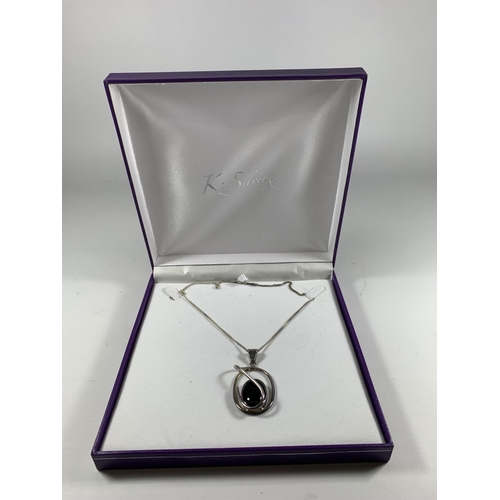 687 - A BOXED SILVER NECKLACE WITH ABSTRACT BLACK STONE DESIGN