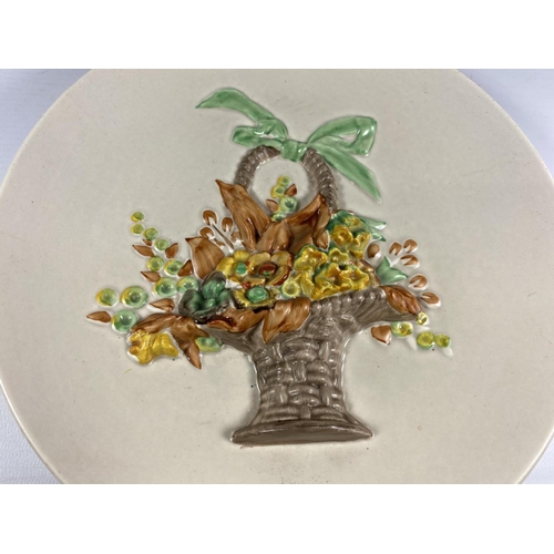 826 - A CLARICE CLIFF POTTERY PLATE WITH BASKET OF FLOWER RELIEF MOULDED DESIGN