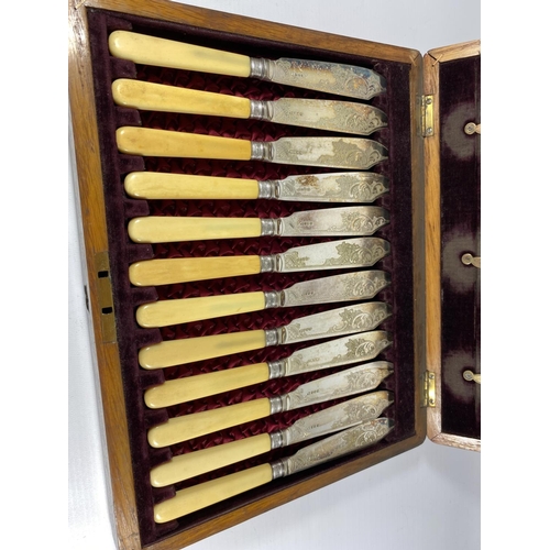 92 - AN OAK CASED CANTEEN OF CUTLERY WITH SHEFFIELD SILVER FERRULES & RED LINED INTERIOR