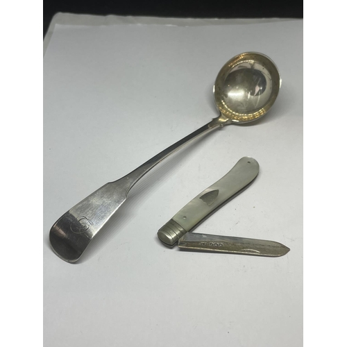 712 - TWO ITEMS - A MOTHER OF PEARL & HALLMARKED SILVER FRUIT KNIFE TOGETHER WITH A BELIEVED SILVER LADLE,... 