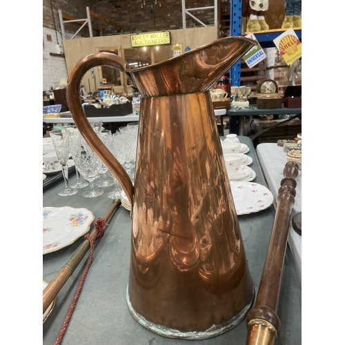 268 - A COPPER BED WARMER TOGETHER WITH A LARGE COPPER HOT WATER JUG