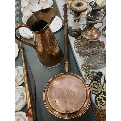 268 - A COPPER BED WARMER TOGETHER WITH A LARGE COPPER HOT WATER JUG