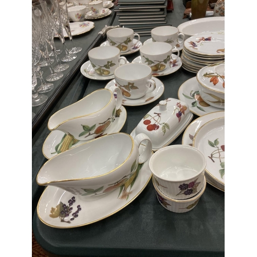 295 - A LARGE QUANTITY OF ROYAL WORCESTER EVESHAM DINNER WARE TO INCLUDE PLATES, CUPS AND SAUCERS, GRAVY B... 