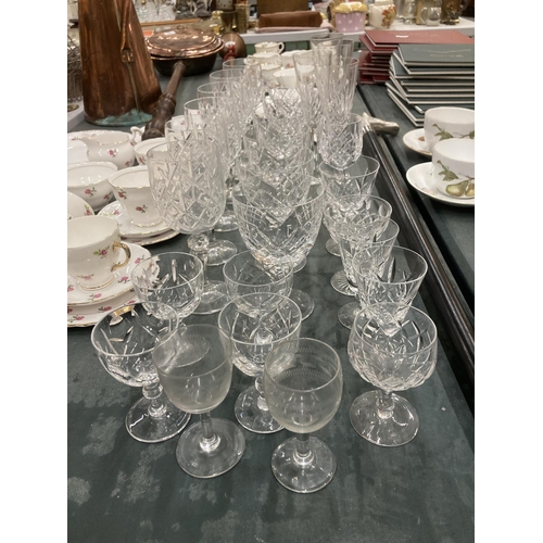 297 - A QUANTITY OF CUT GLASS TO INCLUDE WINE GLASSES, CHAMPAGNE FLUTES, ETC