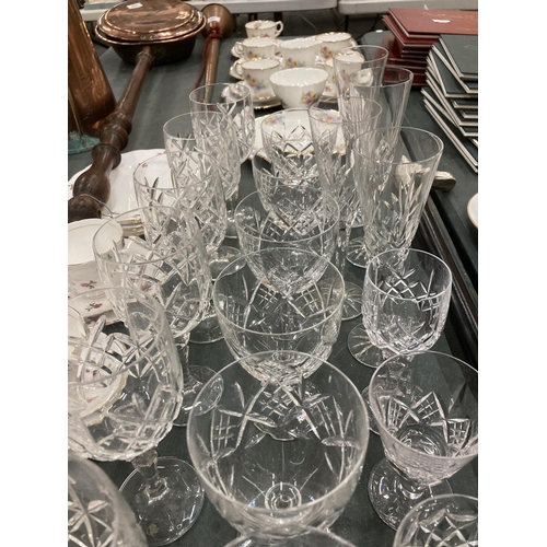 297 - A QUANTITY OF CUT GLASS TO INCLUDE WINE GLASSES, CHAMPAGNE FLUTES, ETC