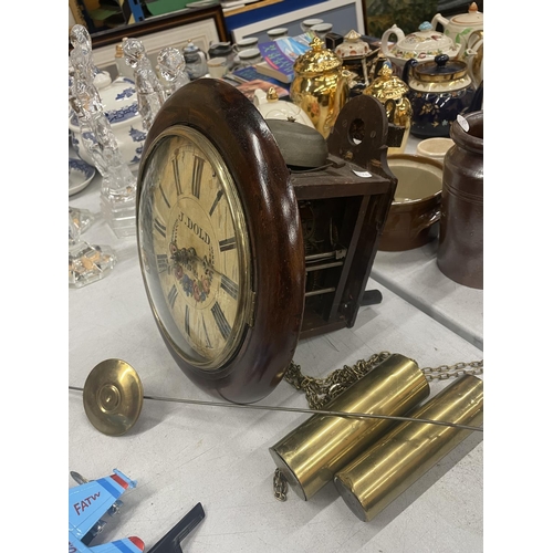 857 - A VINTAGE MAHOGANY CASED WALL CLOCK WITH FLORAL FACE WITH PENDULUM AND WEIGHTS