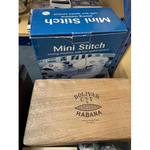 862 - A MINI STITCH SEWING MACHINE WITH TWO SPEED CONTROL TOGETHER WITH A CIGAR BOX, BOOK AND MIRROR ON ST... 