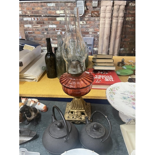 866 - A CRANBERRY GLASS OIL LAMP, TEAPOTS AND COLLECTOR'S PLATES