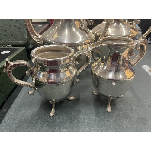 910 - A SILVER PLATED TEASET TOINCLUDE COFFEE POT, TEAPOT, CREAM JUG AND SUGAR BOWL