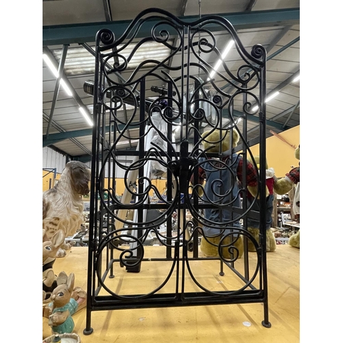 930 - A HEAVY TWELVE BOTTLE METAL WINE RACK WITH DOORS