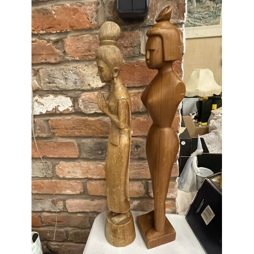 946 - TWO HAND CARVED ORIENTAL STYLE FIGURES OF LADIES HEIGHT 64CM AND 67CM