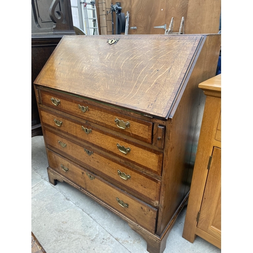 2545B - A GEORGE III OAK AND CROSSBANDED BUREAU WITH FITTED INTERIOR, FOUR GRADUATED DRAWERS ON BRACKET FEET... 