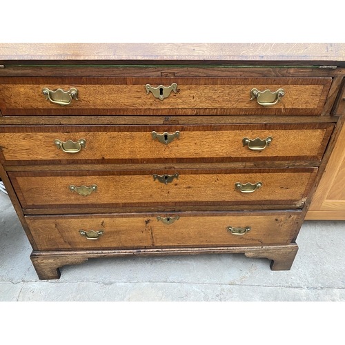 2545B - A GEORGE III OAK AND CROSSBANDED BUREAU WITH FITTED INTERIOR, FOUR GRADUATED DRAWERS ON BRACKET FEET... 