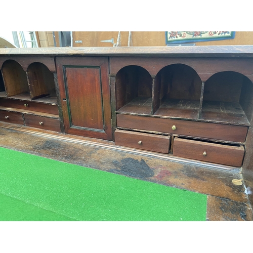 2545B - A GEORGE III OAK AND CROSSBANDED BUREAU WITH FITTED INTERIOR, FOUR GRADUATED DRAWERS ON BRACKET FEET... 