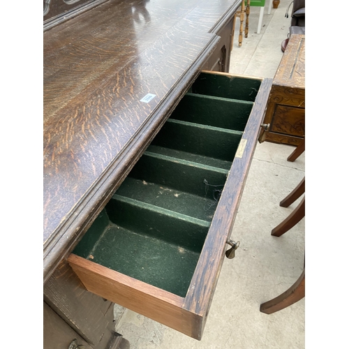 2546 - AN EARLY 20TH CENTURY OAK BREAKFRONT SIDEBOARD WITH RAISED BACK, ENCLOSING TWO CUPBOARDS AND TWO DRA... 