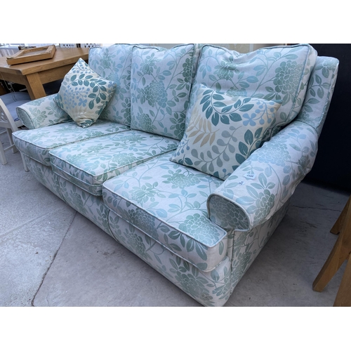 2586 - A MODERN GREEN FLORAL THREE SEATER SETTEE COMPLETE WITH ANTIMACASSARS