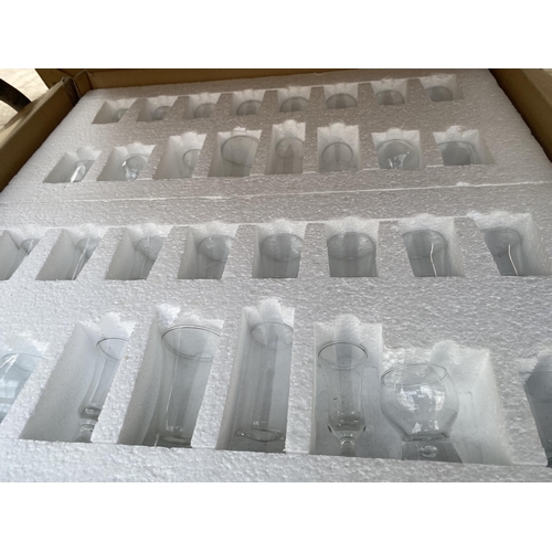 1554 - A LARGE ASSORTMENT OF BOXED GLASS WARE