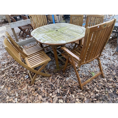 1634 - AN OVAL TEAK GARDEN TABLE AND SIX FOLDING TEAK CHAIRS, TWO BEING CARVERS