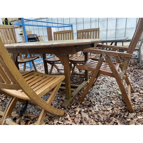 1634 - AN OVAL TEAK GARDEN TABLE AND SIX FOLDING TEAK CHAIRS, TWO BEING CARVERS