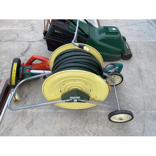 1709 - A HOSE REEL, A FLYMO BATTERY HEDGE TRIMMER AND AN ELECTRIC GRASS STRIMMER