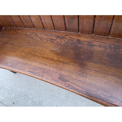 2700 - A VICTORIAN OAK PEW WITH CURVED BACK AND DISHED SEAT, 49.5