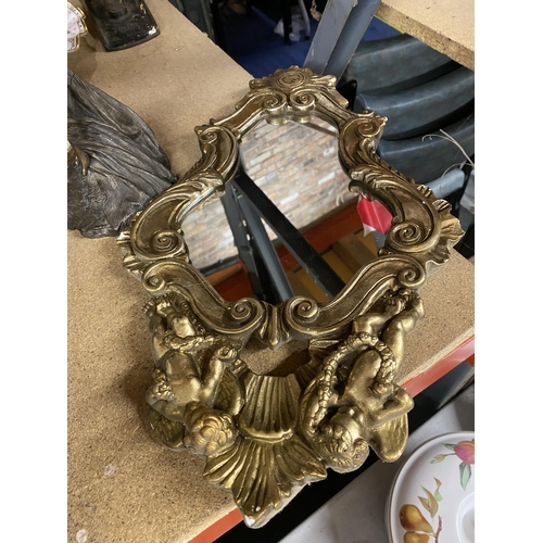 1002 - AN ORNATE GILT FRAMED SMALL MIRROR WITH CHERUB DECORATION AND AN ART DECO STYLE 'SOUL JOURNEYS SPIRI... 