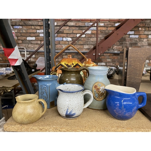 1004 - A QUANTITY OF STUDIO POTTERY JUGS - SOME WITH MAKERS MARKS