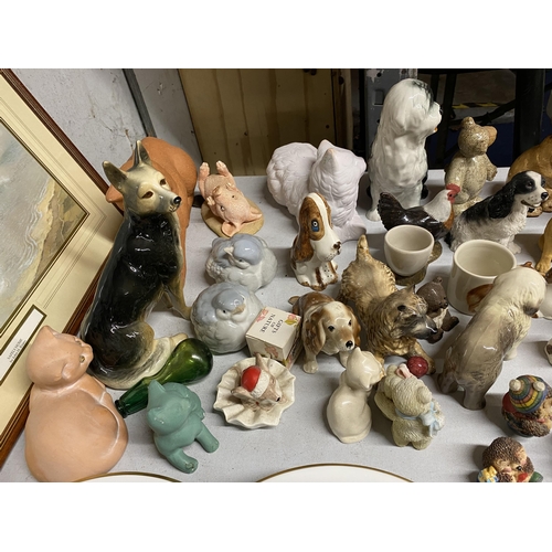 1026 - A LARGE QUANTITY OF CERAMIC ANIMAL FIGURES TO INCLUDE DOGS, CATS, BIRDS, A RABBIT, PIG, ETC