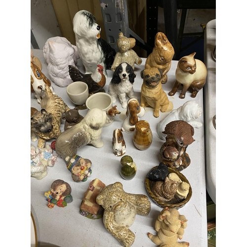 1026 - A LARGE QUANTITY OF CERAMIC ANIMAL FIGURES TO INCLUDE DOGS, CATS, BIRDS, A RABBIT, PIG, ETC