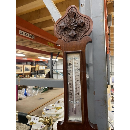 1045 - A MAHOGANY CASED ANEROID BAROMETER WITH CARVING TO THE TOP AND BOTTOM