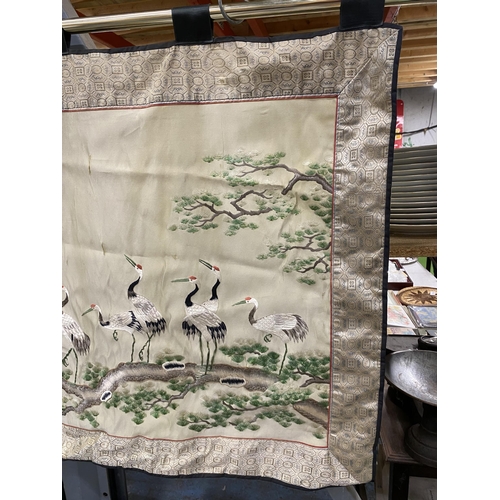 1050 - A SILK ORIENTAL PANEL OF STORKS, SLIGHT DAMAGE TO THE SIDE 93CM X 68CM