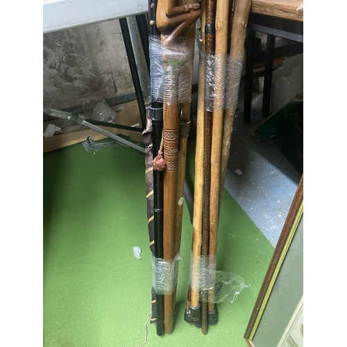 1162 - A COLLECTION OF WOODEN WALKING STICKS TOGETHER WITH A RAIN SHAKER AND UMBRELLA