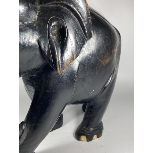 356 - A LARGE HEAVY ANTIQUE EBONISED WOODEN ELEPHANT MODEL, HEIGHT 38CM