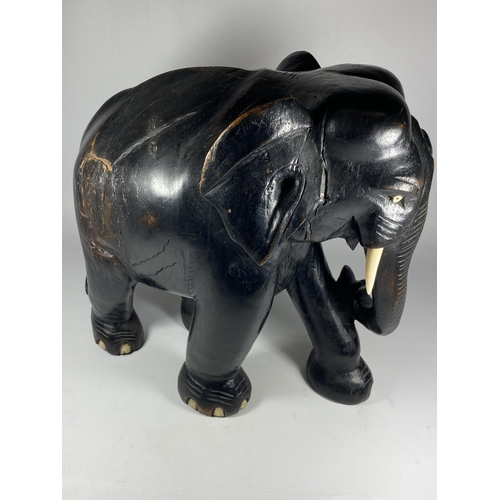 356 - A LARGE HEAVY ANTIQUE EBONISED WOODEN ELEPHANT MODEL, HEIGHT 38CM