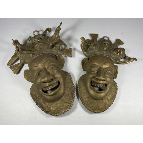 357 - A PAIR OF UNUSUAL TRIBAL / MIDDLE EASTERN BRASS MASKS, LENGTH 27CM