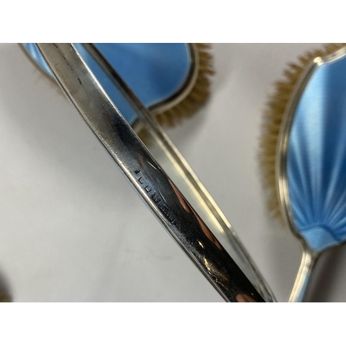 14 - A FIVE PIECE HALLMARKED SILVER BACKED & BLUE GUILLOCHE ENAMEL DRESSING SET COMPRISING TWO HAIR BRUSH... 