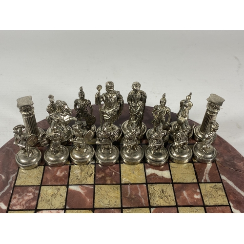 5 - A METAL WARRIOR CHESS SET ON MARBLE BASE, BOARD DIAMETER 26CM