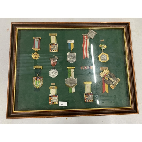 455 - A WOODEN AND GLASS DISPLAY CASE CONTAINING ASSORTED MILITARY MEDALS