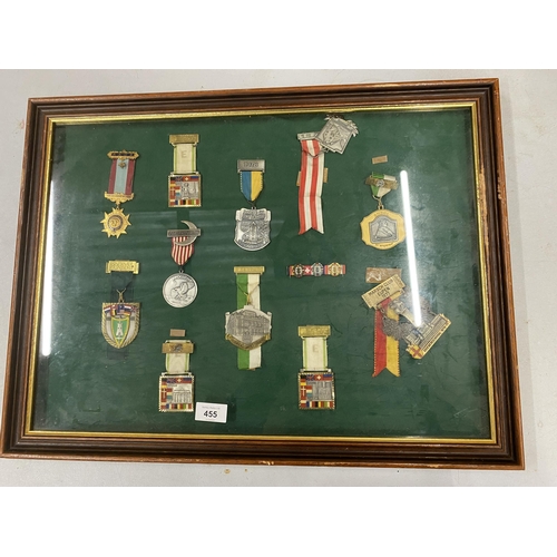 455 - A WOODEN AND GLASS DISPLAY CASE CONTAINING ASSORTED MILITARY MEDALS