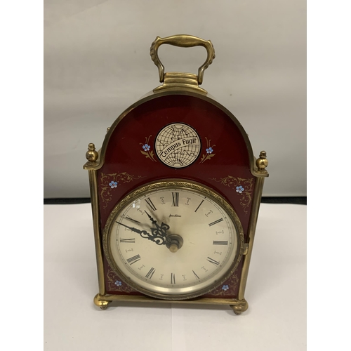110 - A 'BENTIMA' BRASS MANTLE CLOCK WITH A BURGUNDY AND FLORAL DECORATED FRONT HEIGHT 18CM